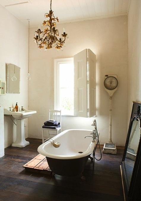 bathroom with light and claw foot tub